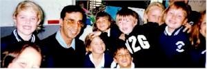 Joseph Natoli, SFSF Project Director, surrounded by happy, enthusiastic children